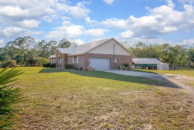 view of property exterior featuring fence, a garage, driveway, and a lawn