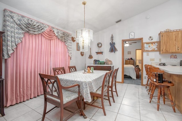 dining area featuring vaulted ceiling, light tile patterned floors, visible vents, and a chandelier