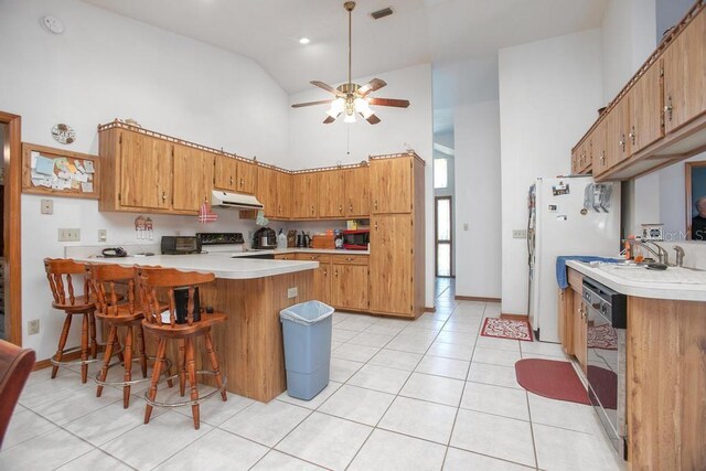 kitchen featuring dishwashing machine, a ceiling fan, a peninsula, range with electric cooktop, and under cabinet range hood