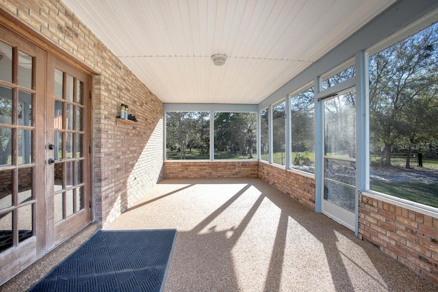 sunroom / solarium featuring french doors