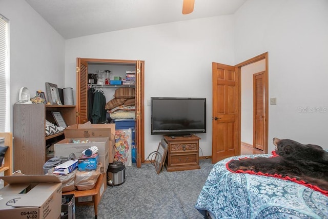 carpeted bedroom with a closet, ceiling fan, and lofted ceiling