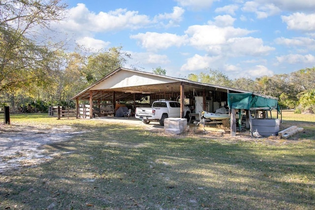 exterior space with a carport, a lawn, and driveway