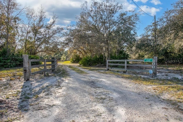 view of street featuring a rural view and a gate