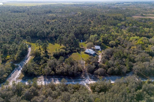 birds eye view of property with a wooded view