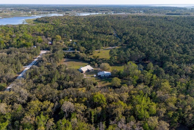 bird's eye view with a wooded view and a water view