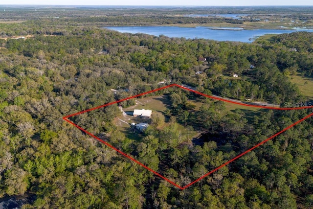 aerial view with a forest view and a water view