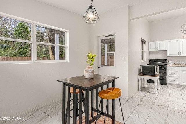 dining space with marble finish floor