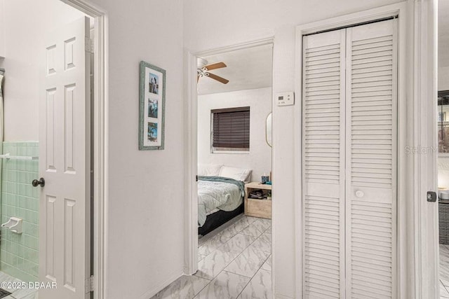 hallway with marble finish floor