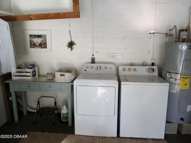 clothes washing area featuring water heater, laundry area, and independent washer and dryer