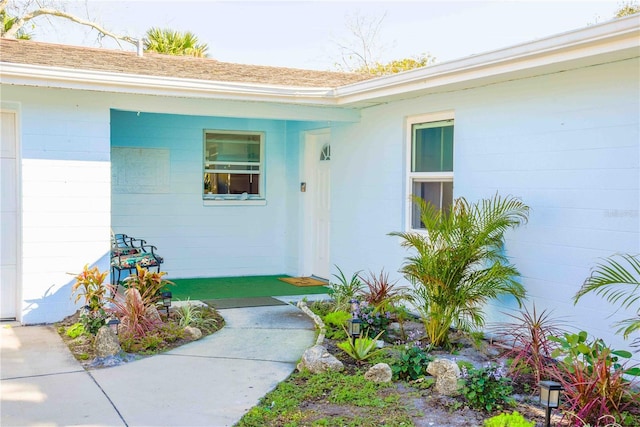 view of exterior entry featuring concrete block siding