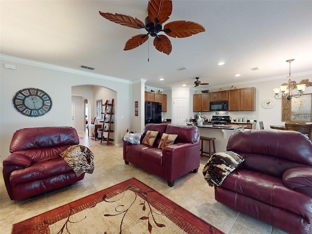 living room with visible vents, recessed lighting, arched walkways, ornamental molding, and ceiling fan with notable chandelier