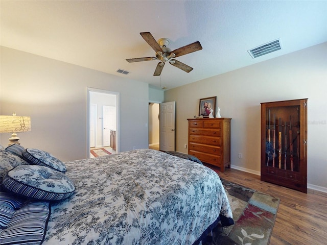 bedroom featuring ceiling fan, wood finished floors, visible vents, and baseboards