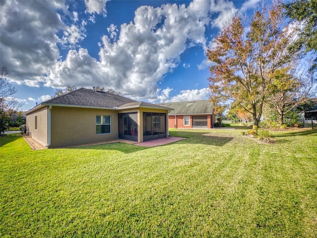 back of property featuring stucco siding, a yard, a shingled roof, and a sunroom