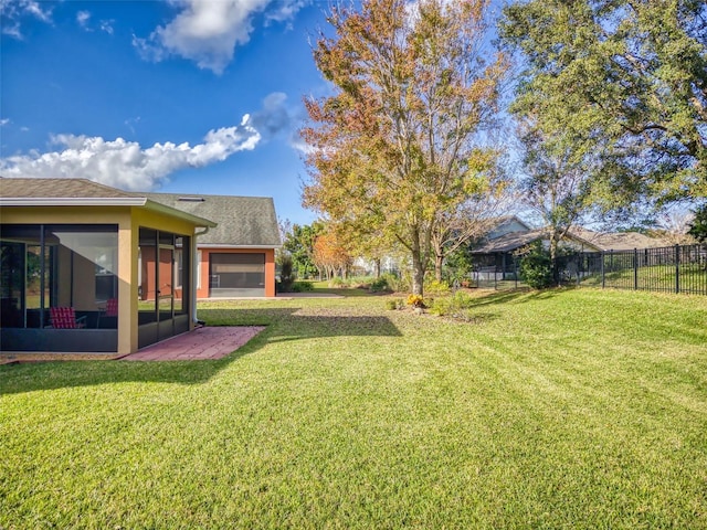 view of yard with fence and a sunroom