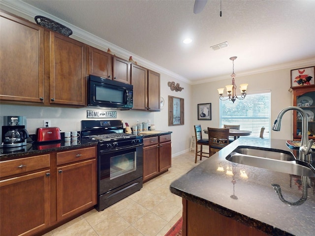 kitchen with visible vents, ornamental molding, a sink, black appliances, and a notable chandelier