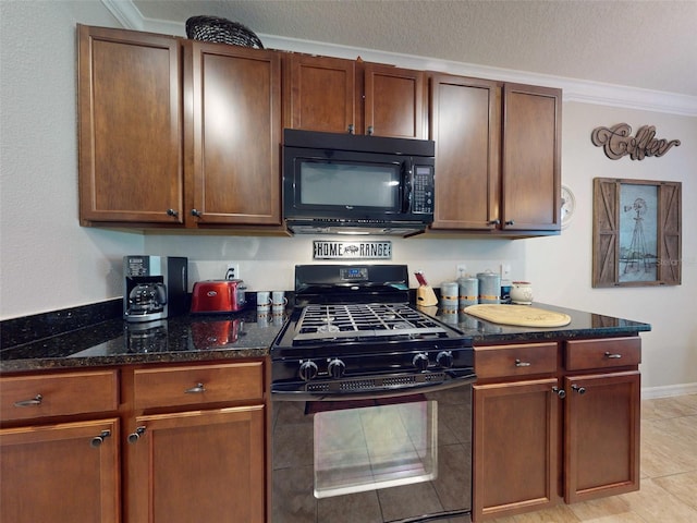 kitchen featuring dark stone countertops, a textured ceiling, black appliances, and ornamental molding