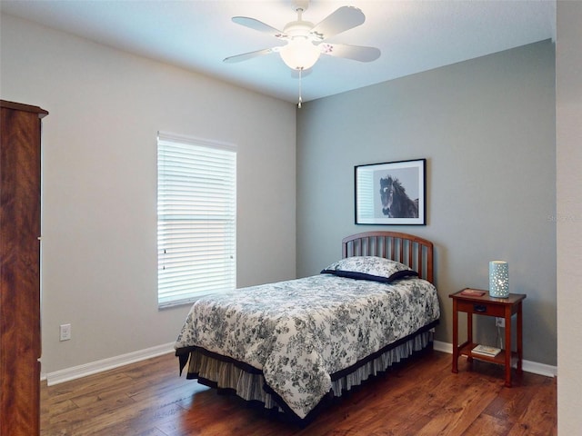 bedroom with a ceiling fan, wood finished floors, and baseboards