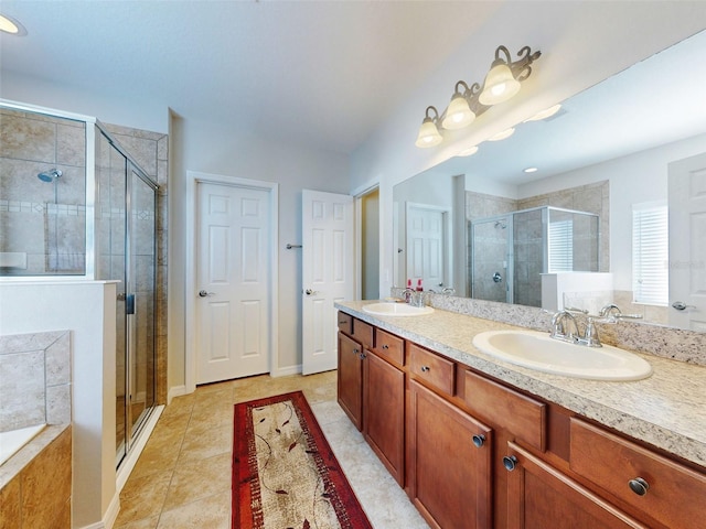 full bathroom with tile patterned flooring, a stall shower, double vanity, and a sink