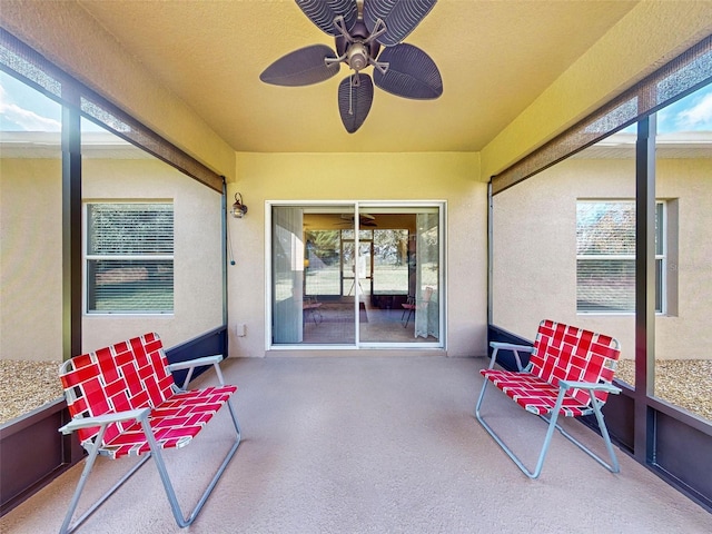 sunroom featuring ceiling fan