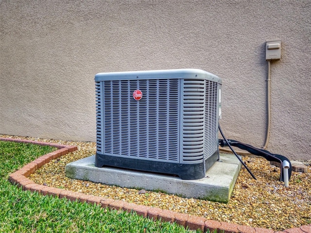 details featuring cooling unit and stucco siding