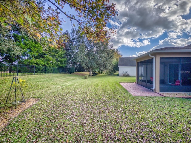 view of yard featuring a sunroom and fence