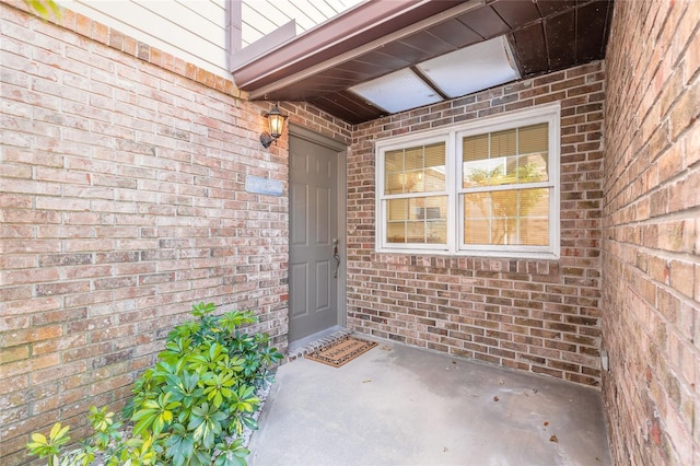 property entrance featuring brick siding