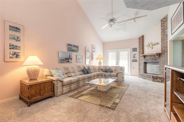 carpeted living area with high vaulted ceiling, a textured ceiling, a fireplace, baseboards, and ceiling fan