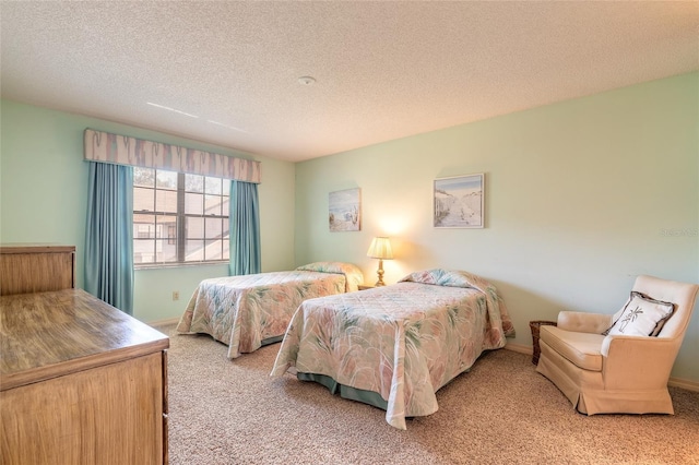 carpeted bedroom featuring baseboards and a textured ceiling