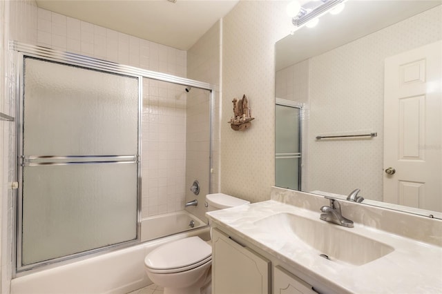 bathroom with enclosed tub / shower combo, toilet, vanity, and wallpapered walls