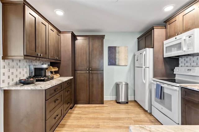 kitchen featuring white appliances, recessed lighting, light wood-style floors, and tasteful backsplash