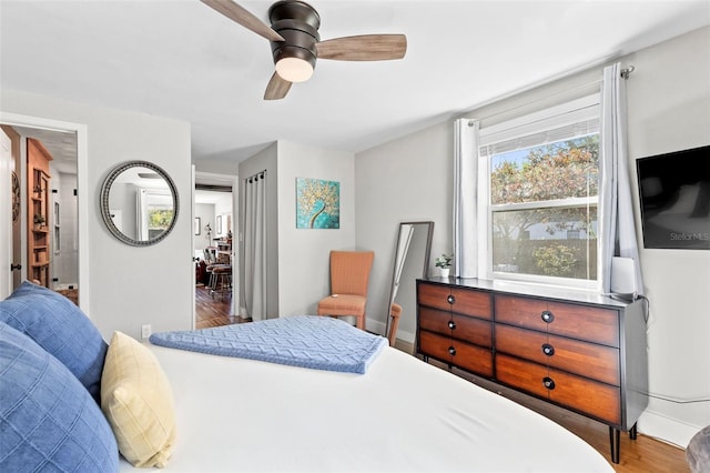 bedroom featuring a ceiling fan and wood finished floors