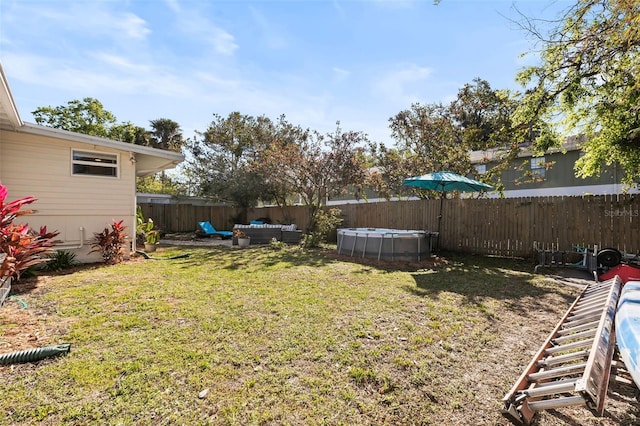 view of yard featuring a fenced in pool, outdoor lounge area, and a fenced backyard