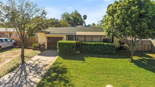 view of front of property with a garage, driveway, a front yard, and fence