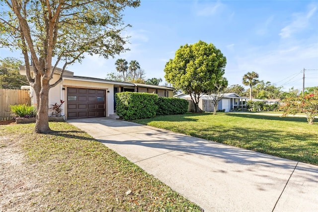 ranch-style house featuring stucco siding, a front lawn, driveway, fence, and an attached garage