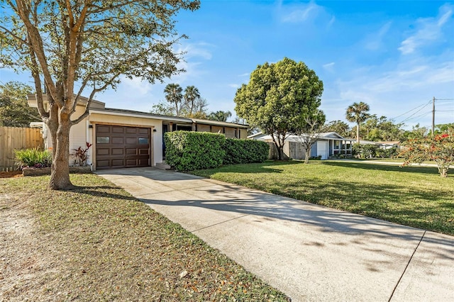 single story home with a front yard, an attached garage, fence, and driveway