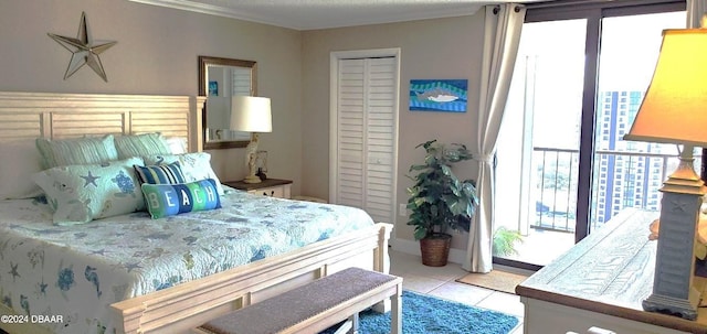 bedroom featuring light tile patterned floors and a closet