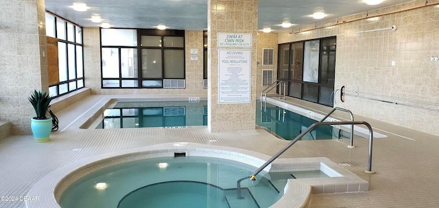 community pool with an indoor in ground hot tub