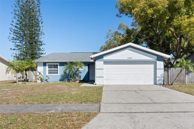 single story home featuring a front yard, an attached garage, driveway, and stucco siding