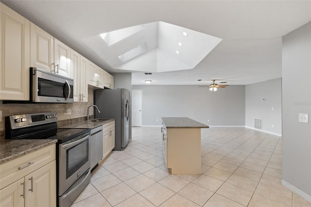 kitchen featuring visible vents, a kitchen island, appliances with stainless steel finishes, a skylight, and light tile patterned flooring