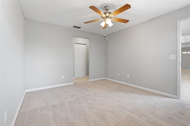 unfurnished room with light carpet, baseboards, visible vents, and ceiling fan