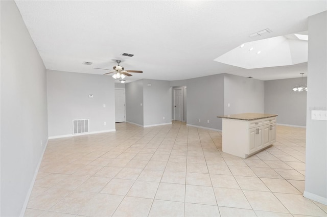 spare room featuring visible vents, baseboards, light tile patterned flooring, and ceiling fan with notable chandelier