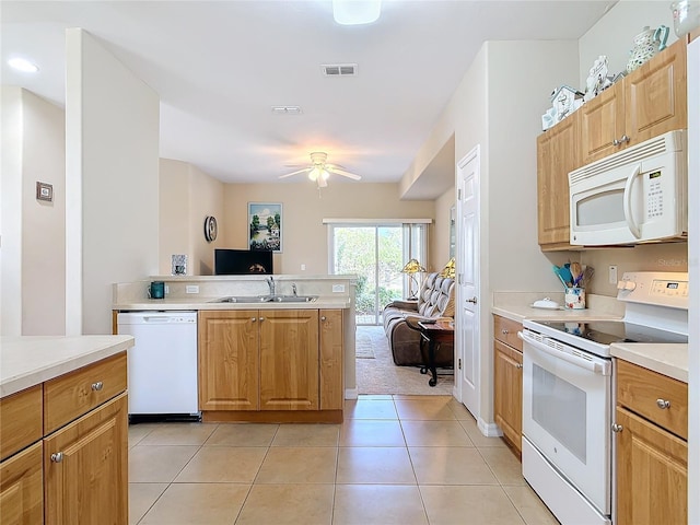 kitchen featuring white appliances, light tile patterned floors, visible vents, a sink, and open floor plan