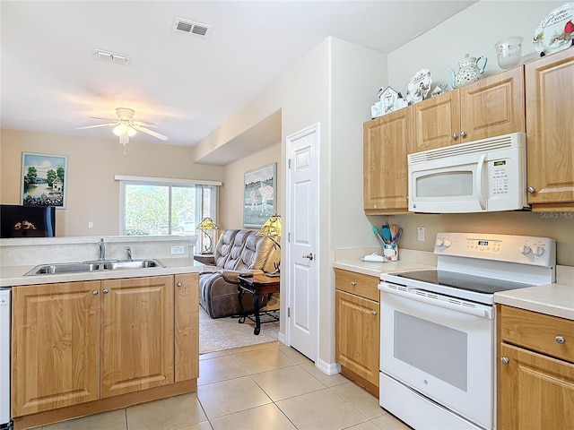 kitchen featuring visible vents, a sink, open floor plan, white appliances, and light countertops