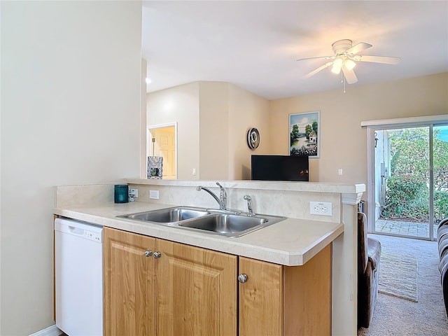 kitchen with a sink, carpet flooring, white dishwasher, ceiling fan, and light countertops