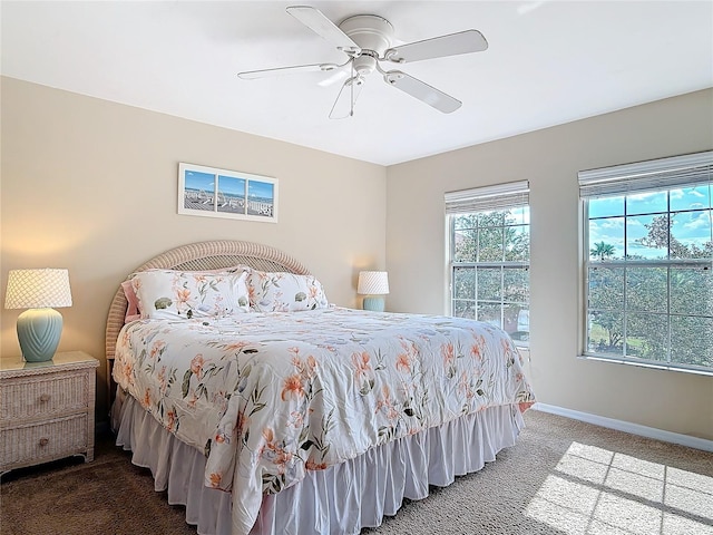 carpeted bedroom with a ceiling fan and baseboards
