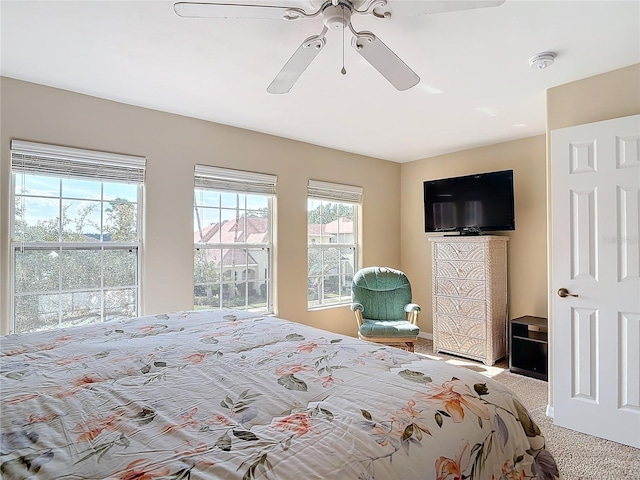 carpeted bedroom featuring ceiling fan
