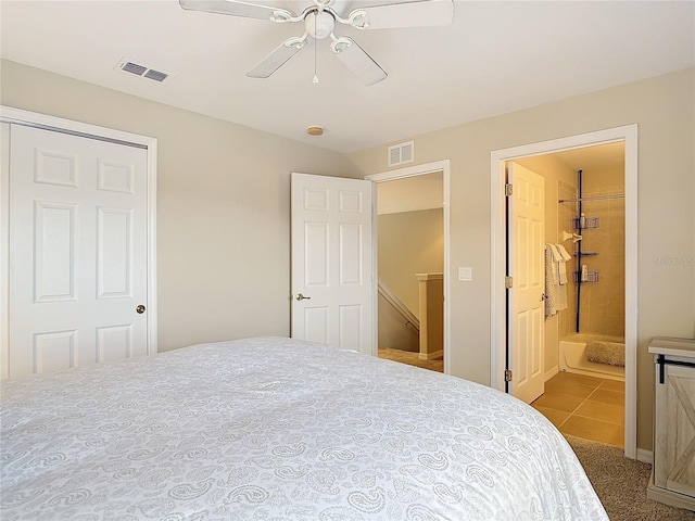 bedroom with ceiling fan, visible vents, ensuite bath, and tile patterned flooring