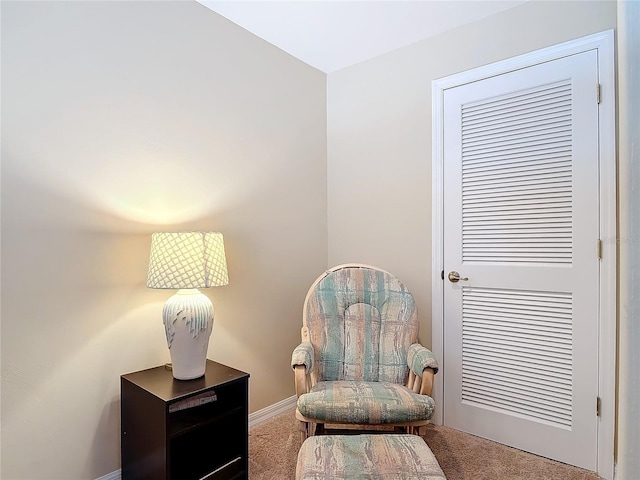 living area featuring carpet flooring and baseboards