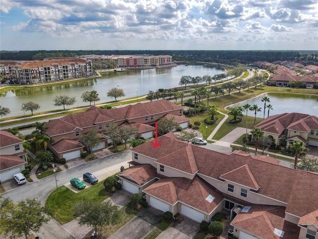 drone / aerial view with a residential view and a water view