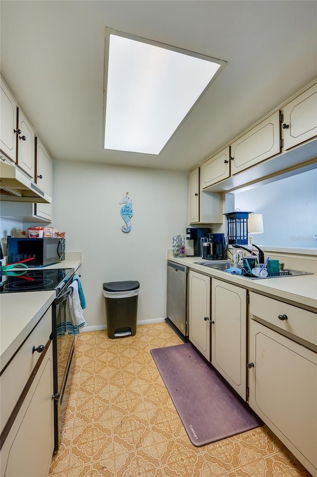 kitchen featuring baseboards, light floors, appliances with stainless steel finishes, and light countertops